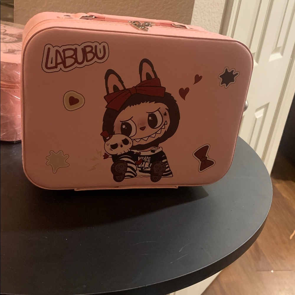 A pink labubu make up case